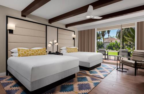 a bedroom with two beds and a balcony at San Diego Mission Bay Resort in San Diego