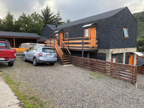 a house with a car parked in front of it at Departamentos KM 5 in Coihaique