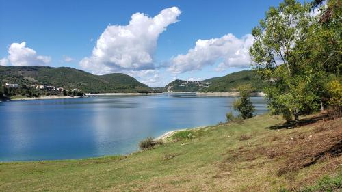 a view of a lake with mountains in the background at Amazing Lake View in Castel di Tora
