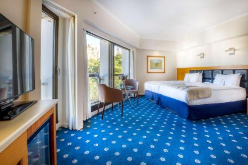 a hotel room with a bed and a television at Best Western Plus Hotel Konak in Izmir