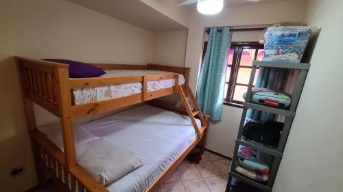 1 dormitorio con 2 literas y ventana en Apartamento Praia do Peró, en Cabo Frío