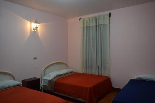 A bed or beds in a room at Hotel Posada del Centro