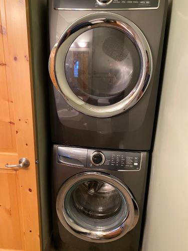 a washing machine and a dryer in a room at 3 BR 3 Bath ski in ski out with private hot tub in Big White