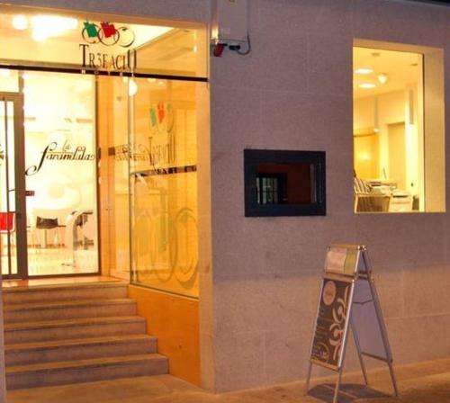 a store with a sign in front of a building at Hotel Trefacio in Zamora