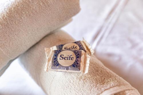 a bar of soap sitting on the arm of a couch at Pousada Bob Pai & Bob Filho in Ilha do Mel