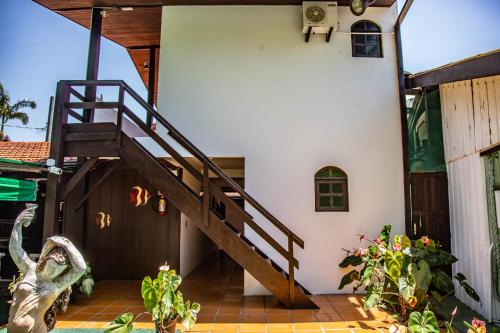 a stairway leading up to a white house at Pousada Bob Pai & Bob Filho in Ilha do Mel