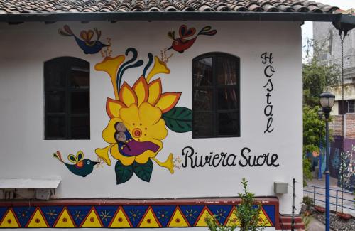 a mural of a flower on the side of a building at Hostal Riviera Sucre in Otavalo
