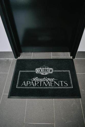 a bathroom mat on the floor of a bathroom at CocoBrew Boutique Apartments in Rockhampton