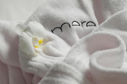 a person holding a towel with a white flower at Mere Hotel in Winnipeg