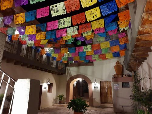 a string of colored prayer flags hanging from a building at Hotel Hacienda Encantada in Real de Catorce