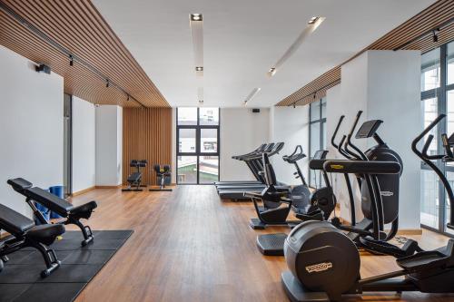 a gym with treadmills and elliptical machines at Sensory Park Urban Hotel in Phnom Penh