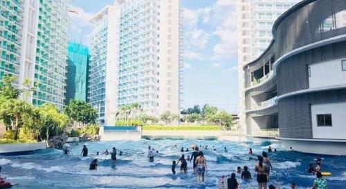 a group of people in a water park with buildings at Holiday Escape Philippines in Manila