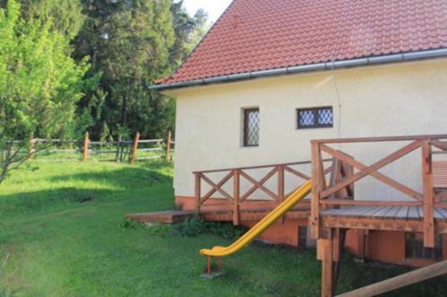a house with a yellow slide next to a building at Chata Horáreň in Smižany
