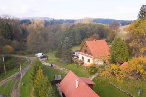 an aerial view of a house with a road and trees at Chata Horáreň in Smižany