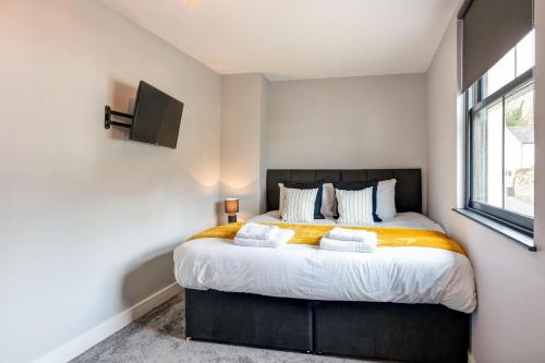 a bedroom with a large bed and a window at Bondgate Hotel East Midlands Airport in Castle Donington
