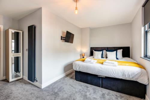 a bedroom with a large bed and a window at Bondgate Hotel East Midlands Airport in Castle Donington