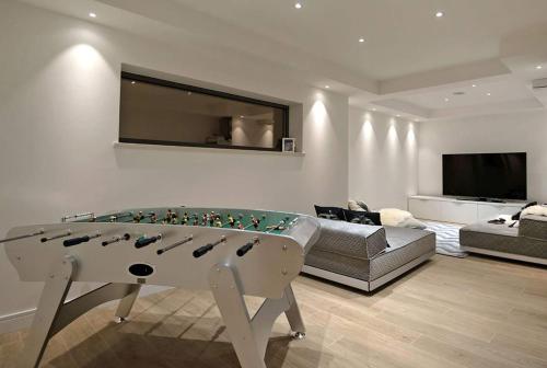 a living room with a pool table and a couch at Luxury Beachfront Villa Silvery Moon with private pool, jacuzzi, sauna and gym on Brac island - Sumartin in Selca