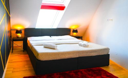 a bedroom with a bed with two towels on it at Modern Suite Naschmarkt in Vienna