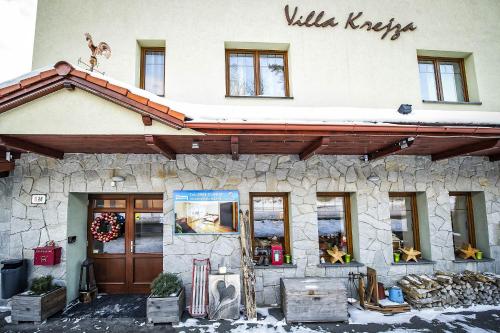 a building with a christmas wreath on the front at Villa Krejza in Smokovce