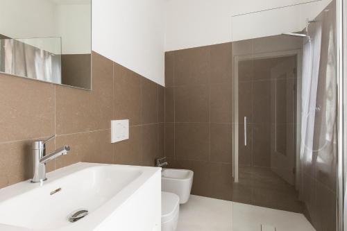 a bathroom with a sink and a toilet at Maraini Apartments by Quokka 360 - strategic location near Lugano station in Lugano