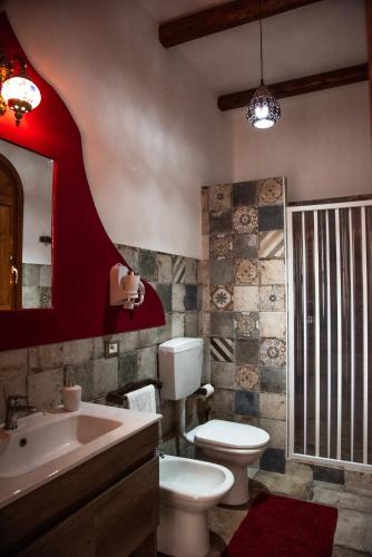 a bathroom with a white toilet and a sink at CASE VACANZE I QUATTROVENTI in Lampedusa