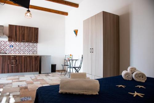 a bedroom with a blue bed with towels on it at CASE VACANZE I QUATTROVENTI in Lampedusa