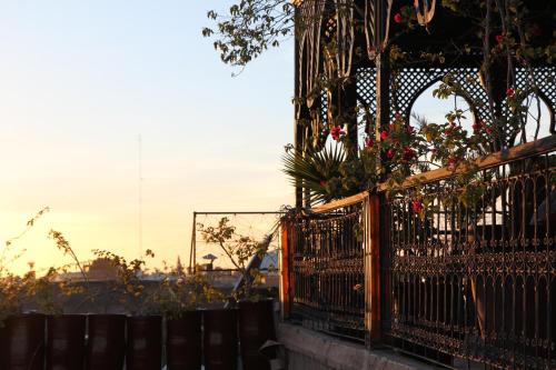 a fence with flowers on top of it at Riad Terra Bahia in Marrakech