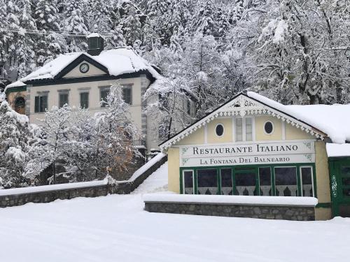 a building with a sign in the snow at Hotel Continental Balneario de Panticosa in Panticosa