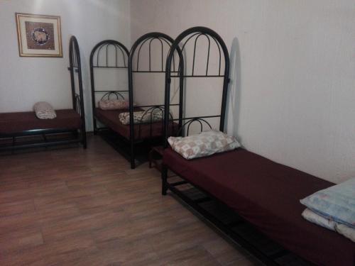 a room with three bunk beds in a room at Fourways Guest Lodge in Johannesburg
