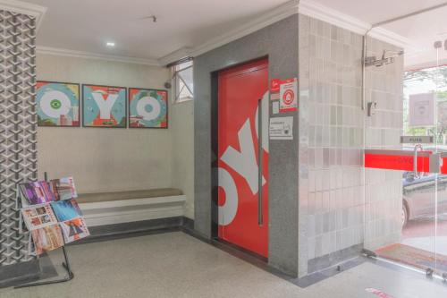 a coke machine in a room with a red door at Mangabeiras Hotel in Goiânia