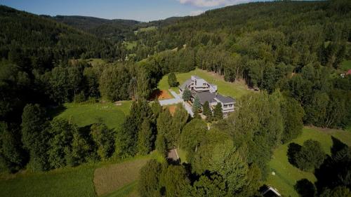 an aerial view of a large house in the forest at Hotel ČESKÁ FARMA in Dolni Dvur