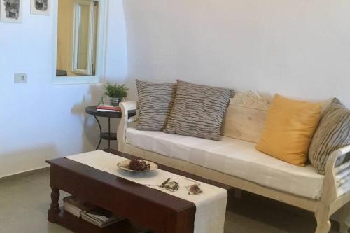 a living room with a couch and a coffee table at Stefani Cave House Santorini in Firostefani
