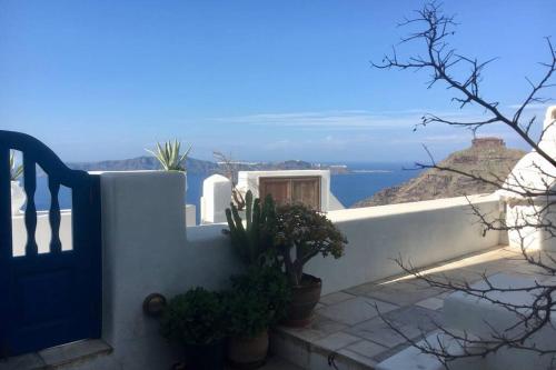 a door to a house with a view of the ocean at Stefani Cave House Santorini in Firostefani