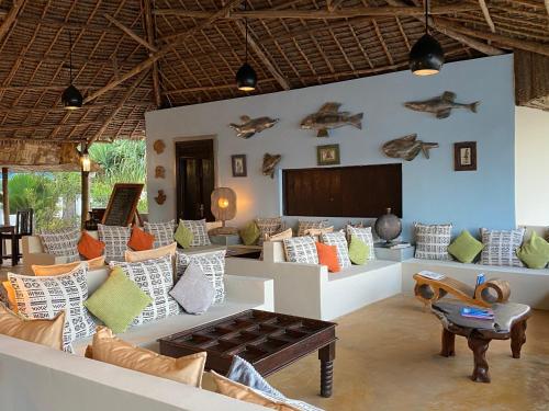 a living room filled with furniture and decor at Jafferji Beach Retreat, in Matemwe