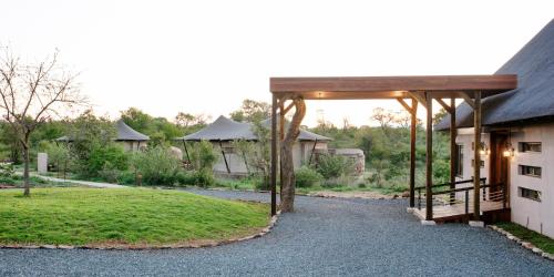 a building with a pavilion in front of a yard at Thabamati Luxury Tented Camp in Timbavati Game Reserve
