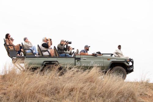 a group of people riding in the back of a truck at Thabamati Luxury Tented Camp in Timbavati Game Reserve