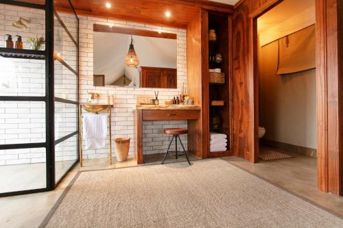 a bathroom with a sink and a mirror at Thabamati Luxury Tented Camp in Timbavati Game Reserve