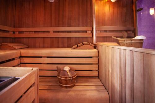 a sauna with two beds and a basket in it at Bellavista Hotel Deluxe Apartments in Riva del Garda