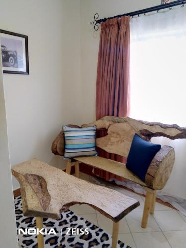 a room with two beds and a window at Machakos Suites Luxury Hotel in Machakos