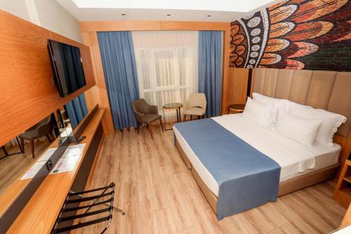Ένα ή περισσότερα κρεβάτια σε δωμάτιο στο The Green Park Gaziantep
