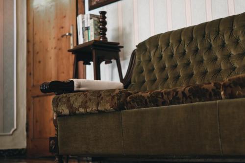 a close up of a couch with a persons leg on it at Casa Anna "a lovely home in Tuscany" in Colle Val D'Elsa