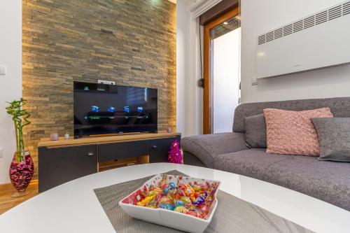 a living room with a couch and a tv at Nirvana 06 in Zlatibor