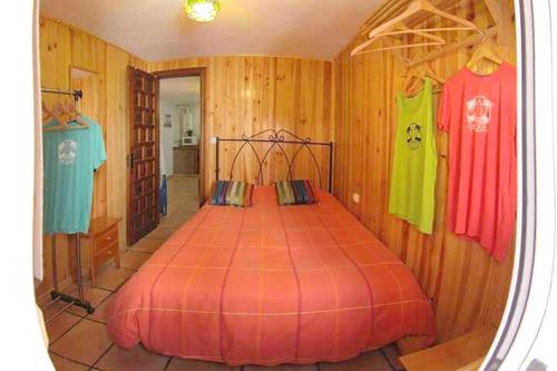 a bedroom with a bed in a room with wooden walls at Comfortable Bungalow in Tarifa, Mountain View. in Tarifa
