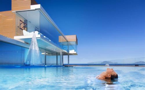 a person in the water in a swimming pool at Charming apartment in Santa Maria, 60 m², sea view in Santa Maria di Castellabate