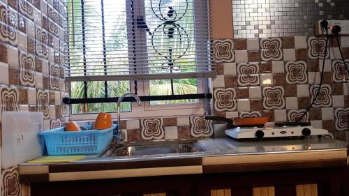a kitchen counter with a sink and a window at One bedroom appartement with city view furnished terrace and wifi at Souillac in Souillac