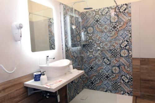 a bathroom with a sink and a shower at HOTEL VILLA ISA in Pescara