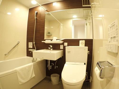 a bathroom with a toilet and a sink and a mirror at Field Hakone Resort in Hakone