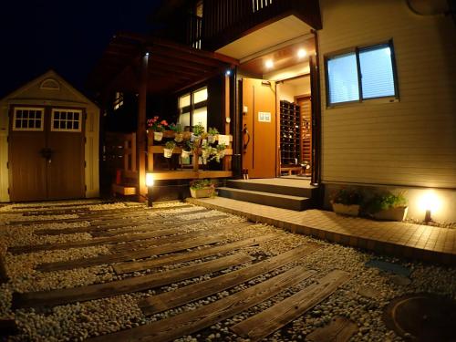 a house with a stone path leading to the front door at Field Hakone Resort in Hakone