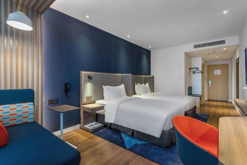 En eller flere senger på et rom på Holiday Inn Express Dali Xiaguan, an IHG Hotel