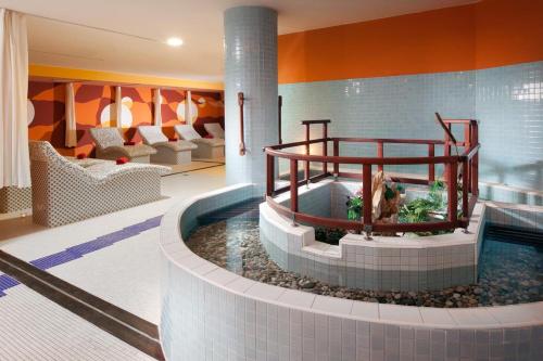 a pool in a hotel lobby with a hot tub at Klostermann Wellness&Spa in Frymburk